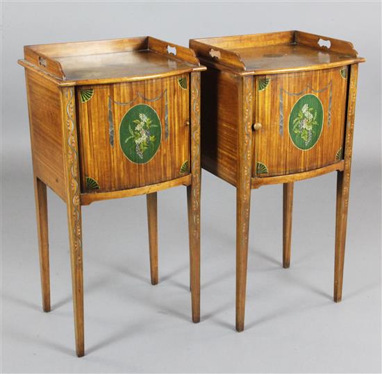 A pair of Edwardian Sheraton Revival painted satinwood bedside cabinets, W.1ft 4in. D.1ft 2in. H.2ft 8in.
